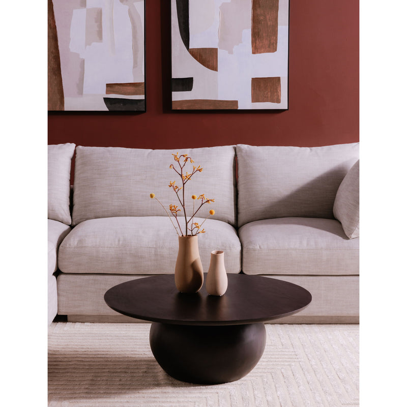 Round blackened acacia coffee table with pedestal base and vase