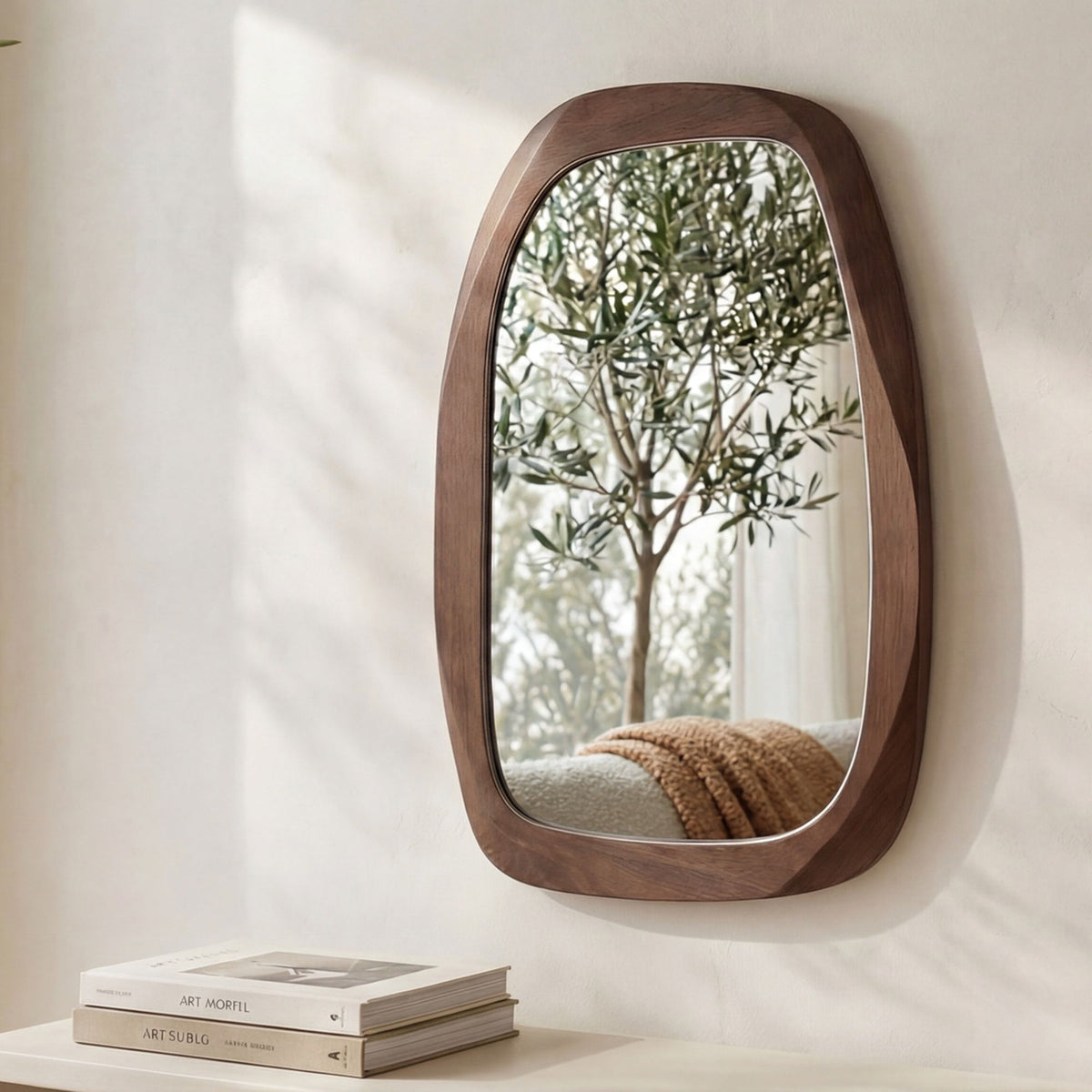 Brown oval wall mirror with thick wood frame, mounted on wall
