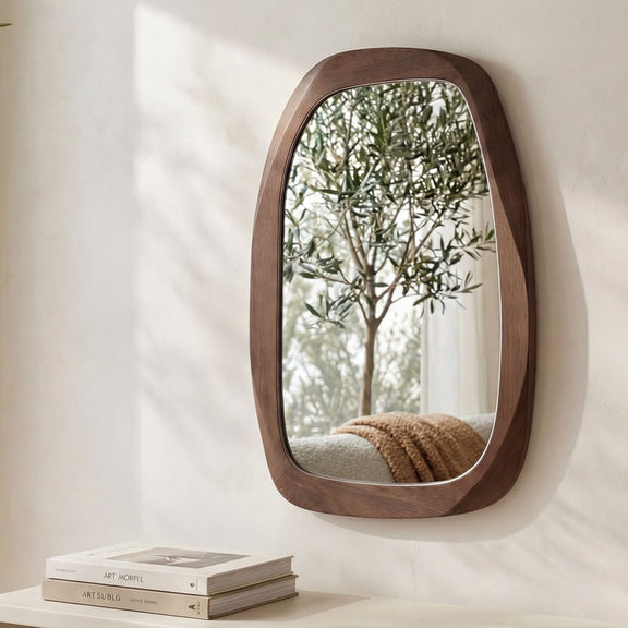 Brown oval wall mirror with thick wood frame, mounted on wall