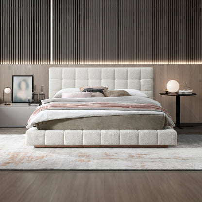 Beige upholstered bed with tufted headboard, striped bedding and padded frame
