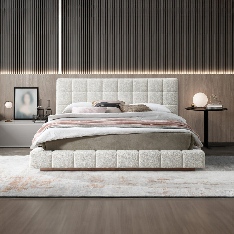 Beige upholstered bed with tufted headboard, striped bedding and padded frame