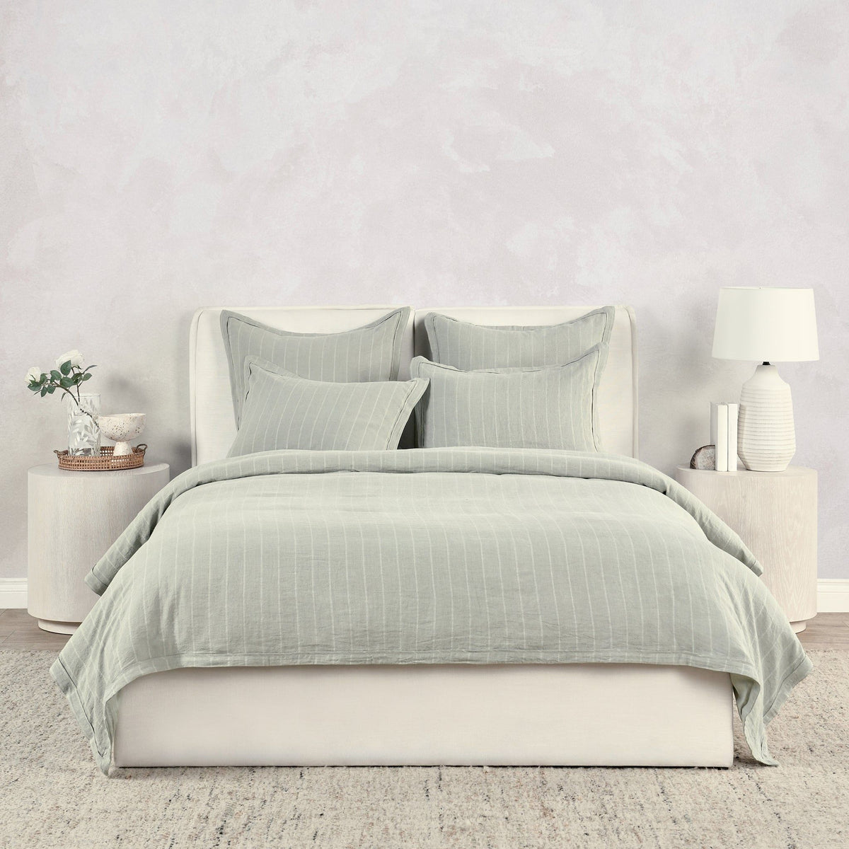 Light green king duvet cover with narrow vertical stripes, neatly styled bedding