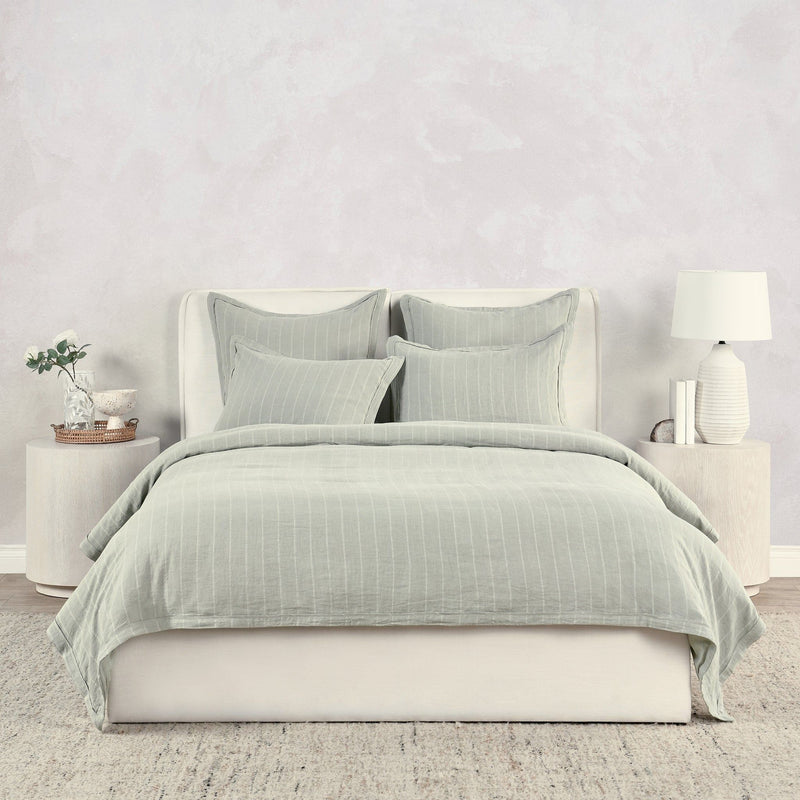 Light green king duvet cover with narrow vertical stripes, neatly styled bedding