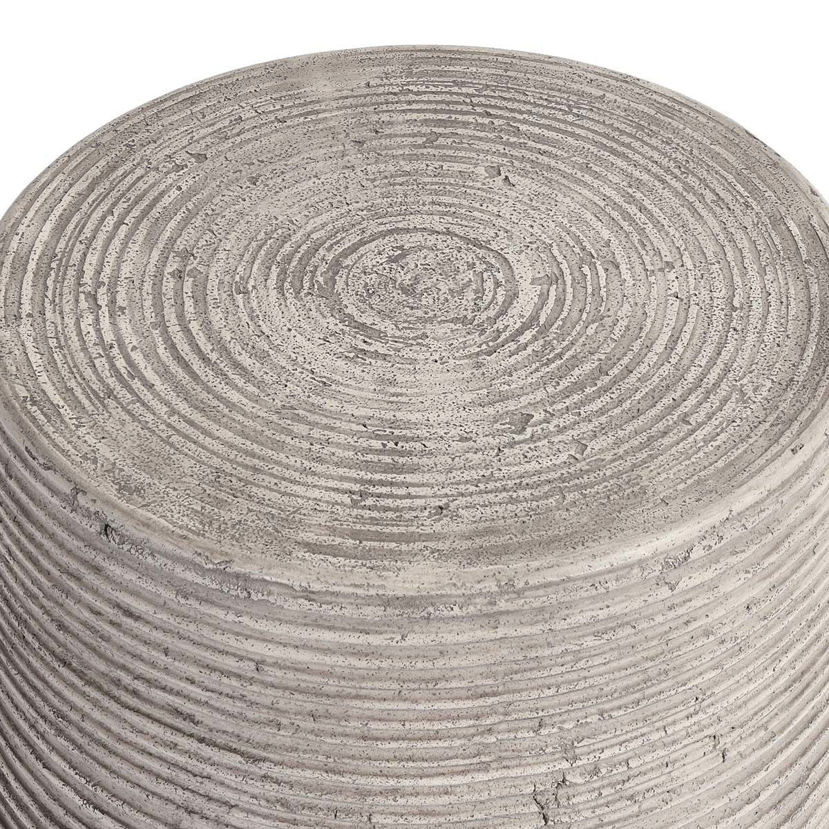 Gray outdoor table top close-up with concentric ridges and subtle speckle marks