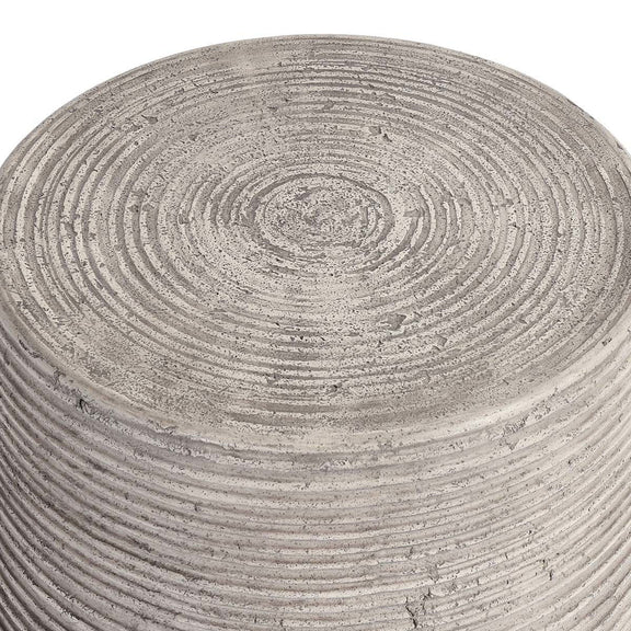 Gray outdoor table top close-up with concentric ridges and subtle speckle marks
