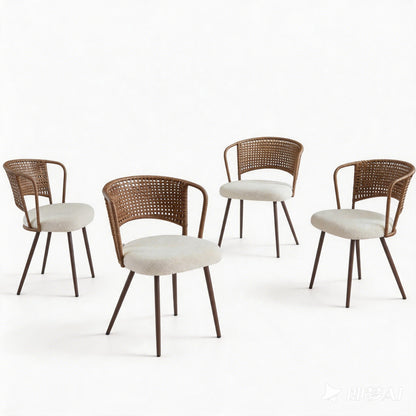 Set of wicker dining chairs with light seat cushions and woven backs on wooden legs