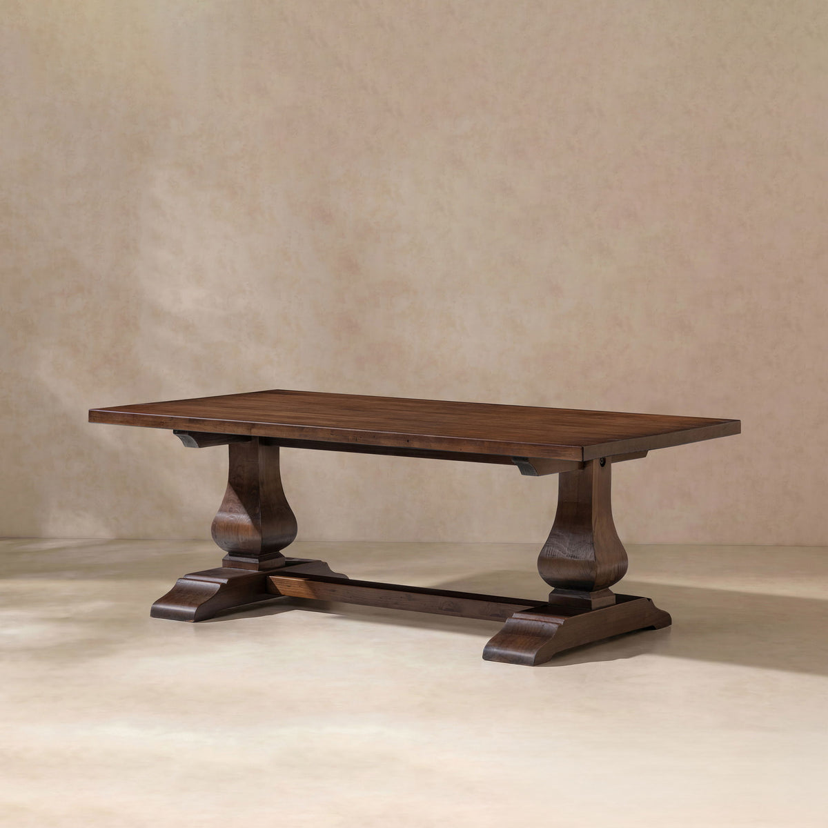 Dark brown rectangular coffee table with turned pedestal legs and lower shelf