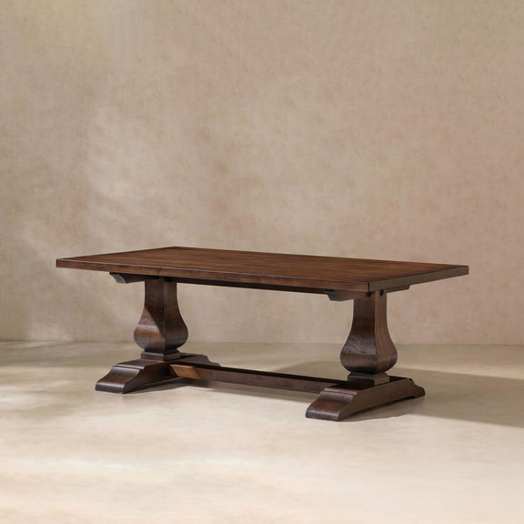 Dark brown rectangular coffee table with turned pedestal legs and lower shelf