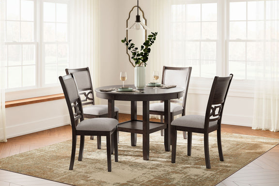 Brown round dining table set with four gray-upholstered chairs