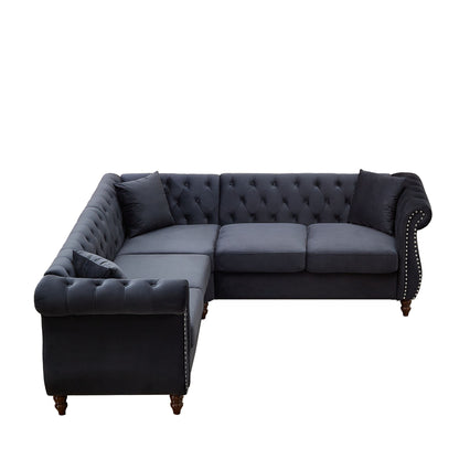 L-shaped corner sofa in dark navy fabric with tufted back and padded armrest cushions.