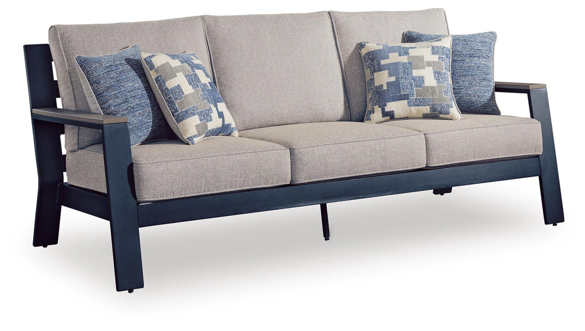 Blue cushion sofa with gray seat and three patterned blue-and-white throw pillows