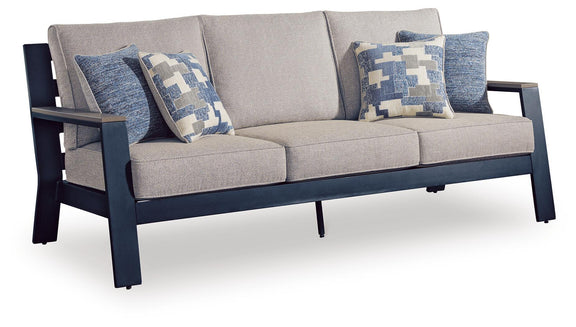 Blue cushion sofa with gray seat and three patterned blue-and-white throw pillows