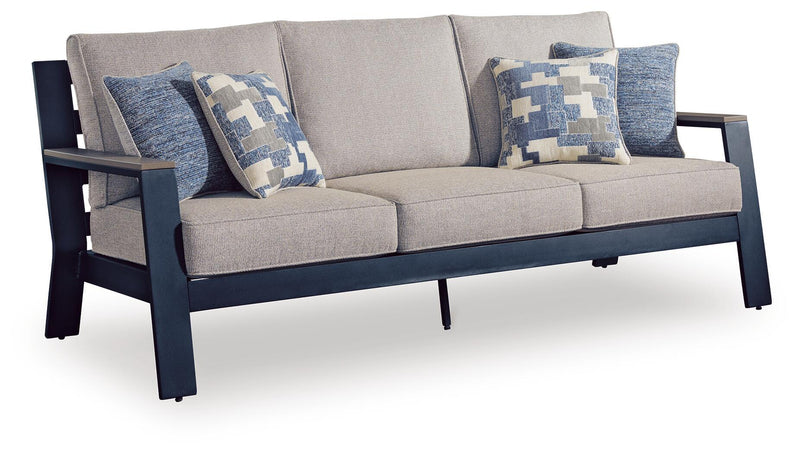 Blue cushion sofa with gray seat and three patterned blue-and-white throw pillows