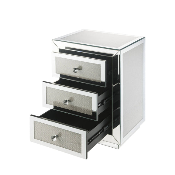 Silver mirrored accent table with three drawer fronts, metal knobs, glossy sides.