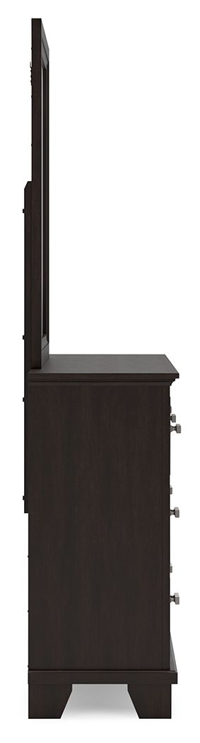 Dark brown dresser side view with hardware and drawers, tall mirror frame