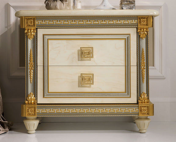 Beige nightstand with white marble-look top, gold-trim drawer and decorative legs.