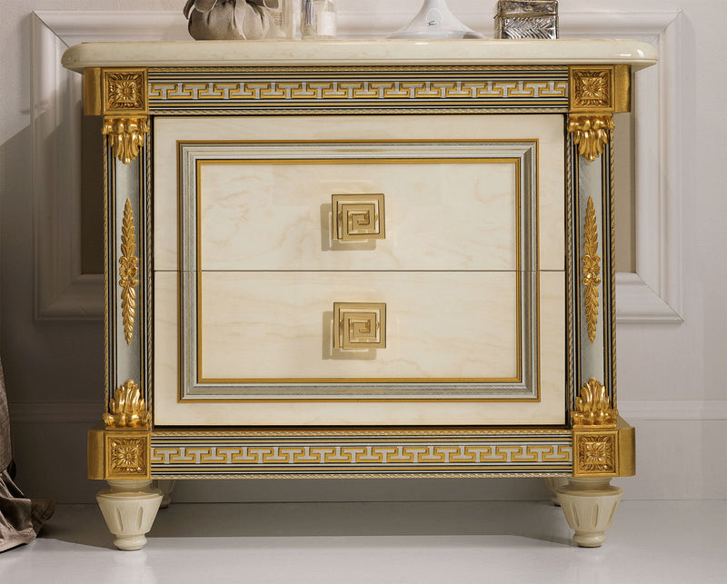 Beige nightstand with white marble-look top, gold-trim drawer and decorative legs.