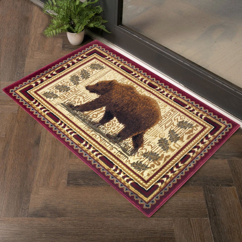 Lodge area rug with beige field, dark bear silhouette, and red border