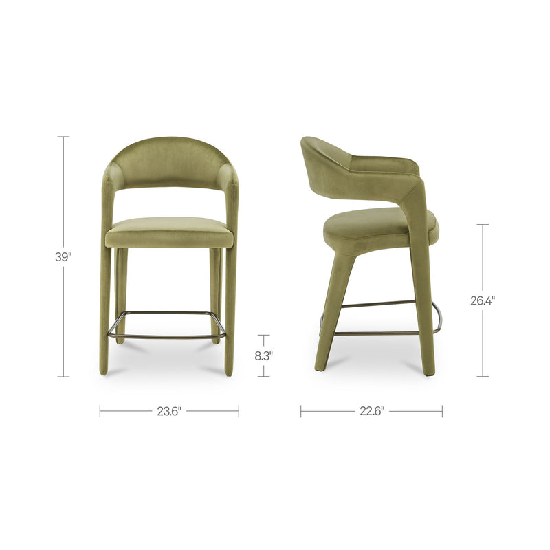 Olive-green velvet counter stool with curved arms, cushioned seat, and metal foot ring.
