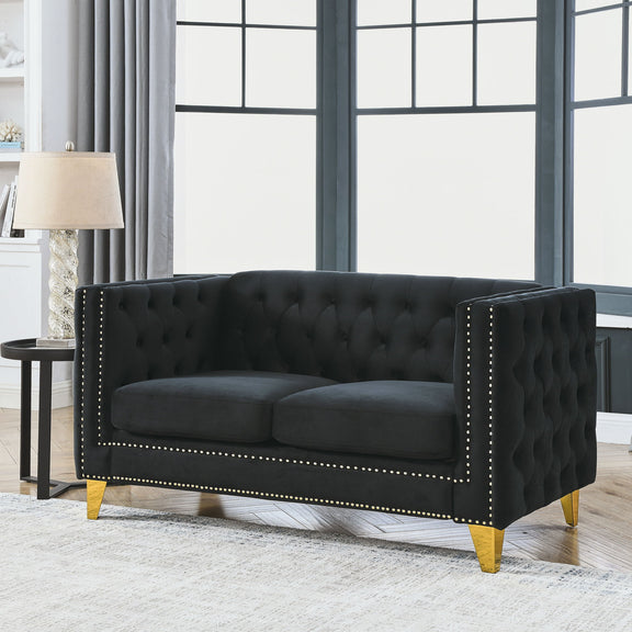 Black button-tufted loveseat with studded trim, padded arms, and gold-toned legs