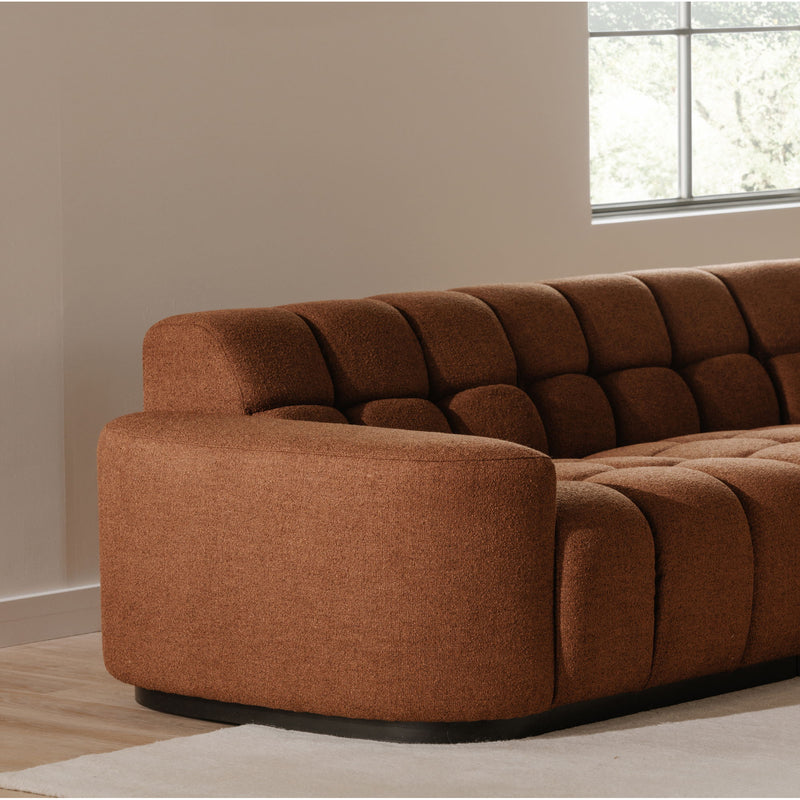Rust-brown sectional sofa corner with rounded arm and tufted seat cushions