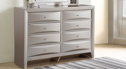Light gray dresser with 8 drawers and silver knobs, curved drawer fronts