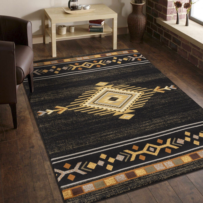 Southwest area rug with black field, large gold-and-tan medallion and patterned border