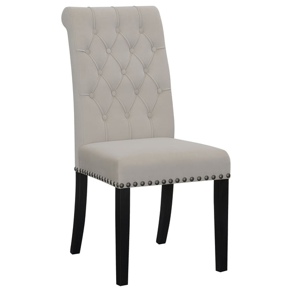 Beige tufted rolled backrest side chair with nailhead trim and dark wooden legs