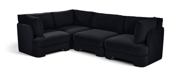Black velvet sectional sofa with plush arms, chaise corner, and matching cushions