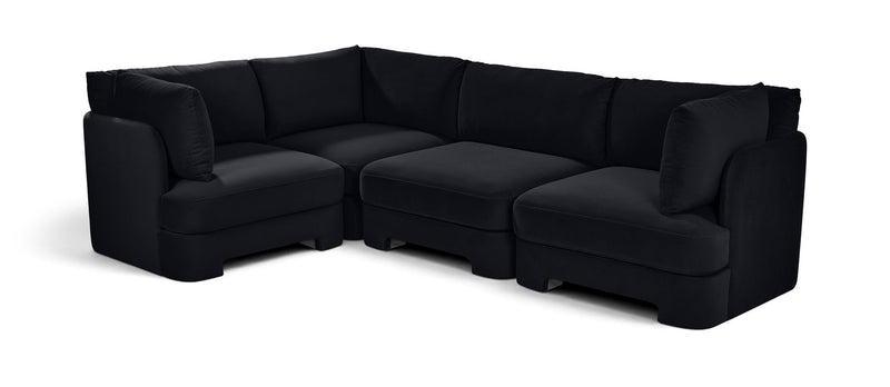 Black velvet sectional sofa with plush arms, chaise corner, and matching cushions