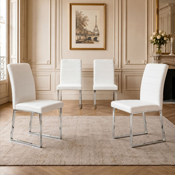 White upholstered dining chairs set with curved backs and padded seats on metal legs
