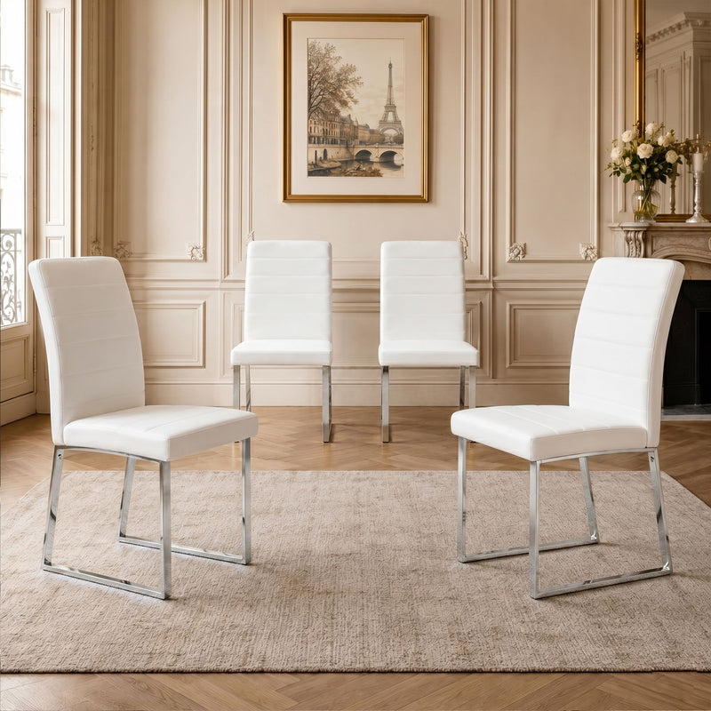 White upholstered dining chairs set with curved backs and padded seats on metal legs