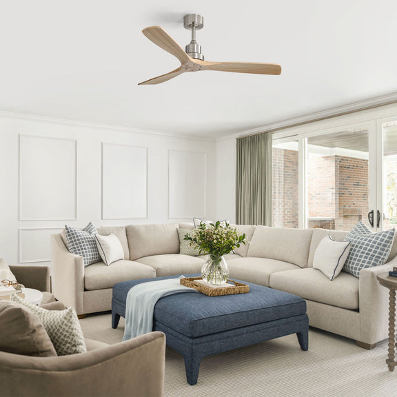 Light wood three-blade ceiling fan installed in a living room ceiling