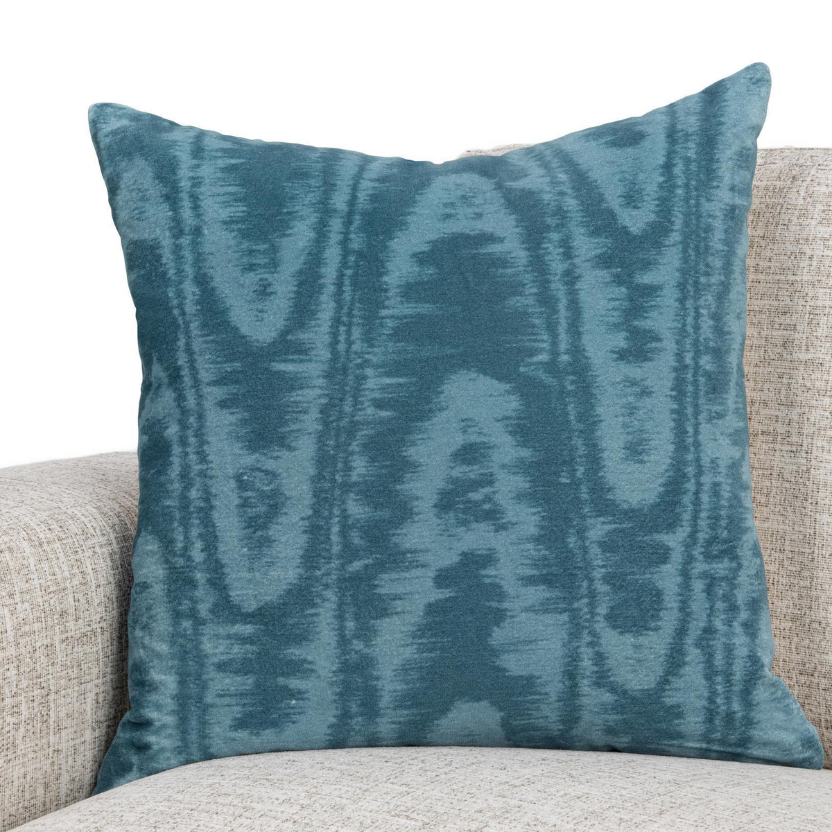 Blue patterned 22 x 22 inch pillow on light sofa