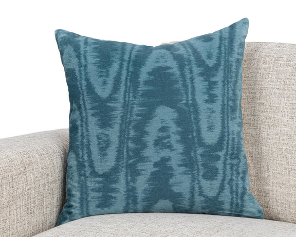 Blue patterned 22 x 22 inch pillow on light sofa