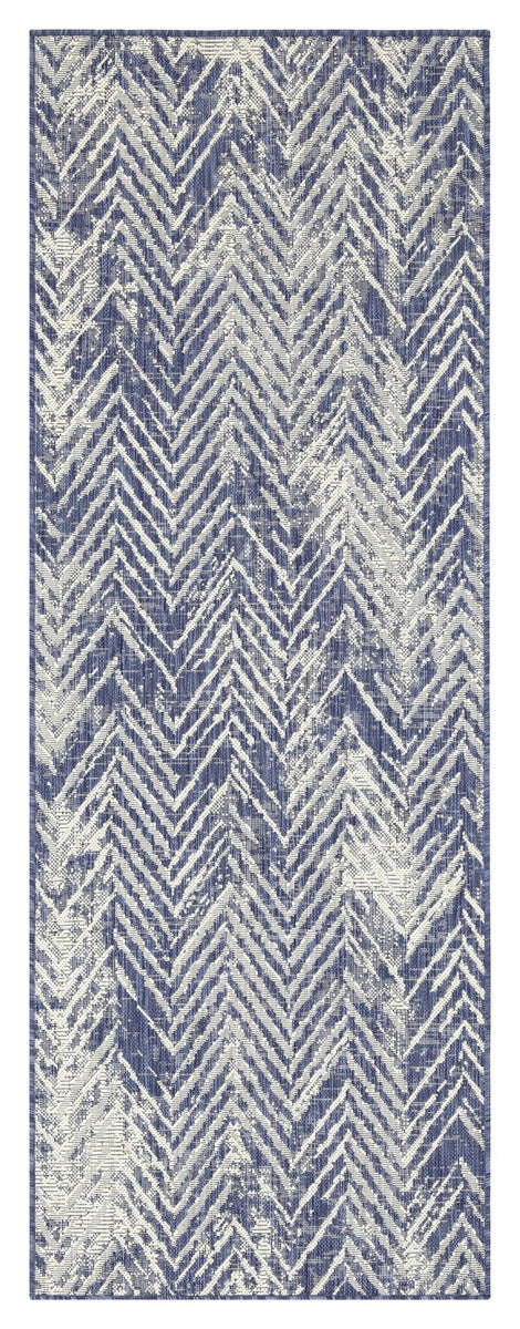Blue indoor/outdoor area rug close-up showing textured zigzag chevron weave.