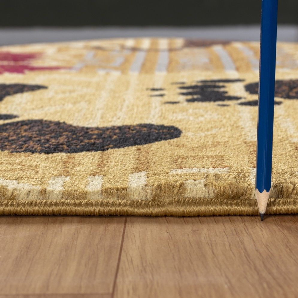 Close-up beige rug pile and border trim with animal silhouettes and geometric design