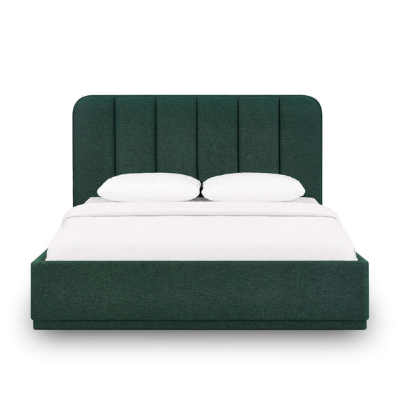 Dark green upholstered bed with arched headboard, panel detailing, and white bedding.