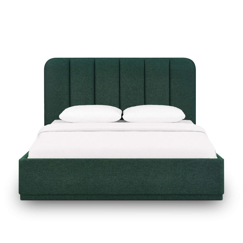 Dark green upholstered bed with arched headboard, panel detailing, and white bedding.