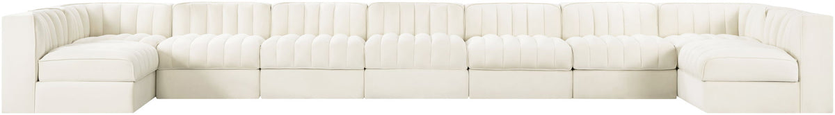 White armless velvet modular sectional with tufted back cushions and multiple seat sections