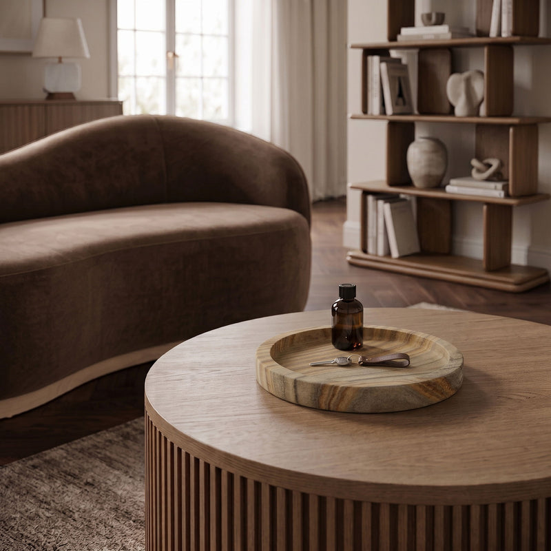 Round sandstone serving tray with striped stone top on a table