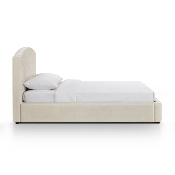 Upholstered platform bed with arched headboard, cream frame, white bedding set.