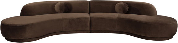 Dark brown velvet sectional sofa with tufted cushions and curved chaise profile
