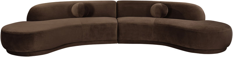 Dark brown velvet sectional sofa with tufted cushions and curved chaise profile