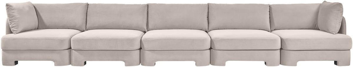 Gray velvet upholstered sectional sofa with clean-lined modular seating and back pillows