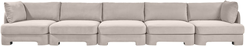 Gray velvet upholstered sectional sofa with clean-lined modular seating and back pillows