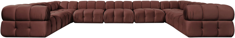 Dark red velvet sectional with tufted seat cushions and curved corner arms