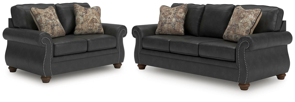 Living room set with dark gray loveseat and sofa, nailhead trim, patterned accent pillows