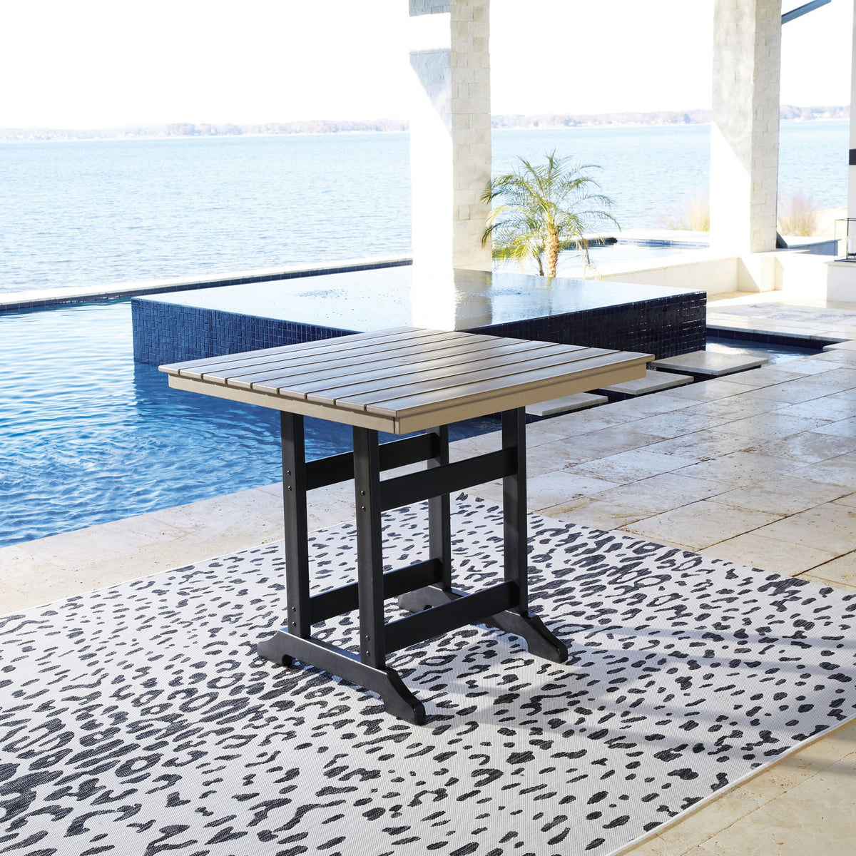 Counter-height dining table with driftwood slat top and black base