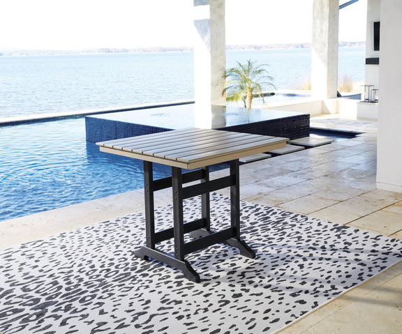 Counter-height dining table with driftwood slat top and black base